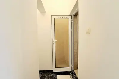 a bathroom with a glass shower door in a room at Cozy 1-Bedroom flat in the very Center of Sofia in Sofia