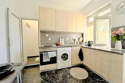 a kitchen with a washer and dryer in it at Cozy 1-Bedroom flat in the very Center of Sofia in Sofia