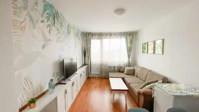 a living room with a couch and a tv at Belvedere Holiday Club H62 Mountains View in Bansko