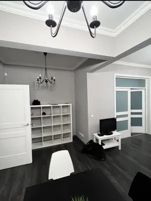 a living room with a tv and a desk at Doctors Garden Appartment in Sofia