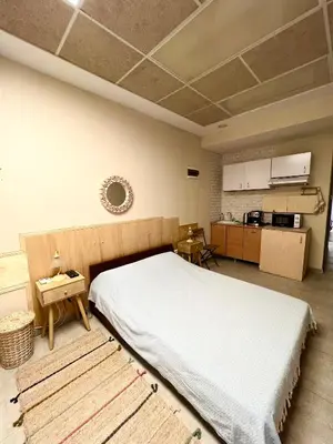 a bedroom with a large bed and a kitchen at Time Traveling Apartment Sofia Mladost District in Sofia