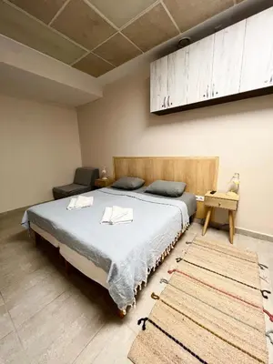a bedroom with a large bed and a rug at Time Traveling Apartment Sofia Mladost District in Sofia