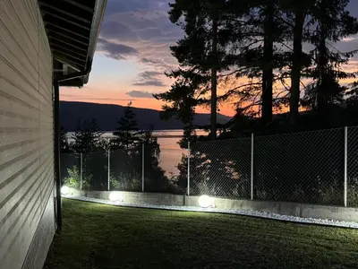 a fence with lights on the side of a house at Villa Siesta Dospat in Dospat