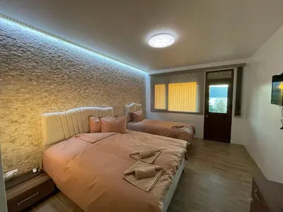 a bedroom with a bed with a bow on it at Villa Siesta Dospat in Dospat
