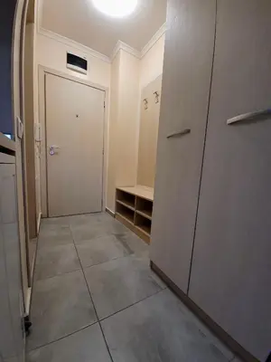 a hallway with a door and a tiled floor at Romantic Studio in Sofia