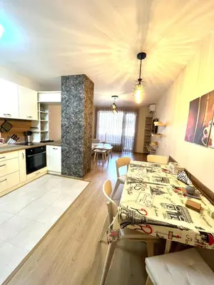 a kitchen and living room with a table and chairs at Апартамент Ренета Apartment Reneta in Velingrad