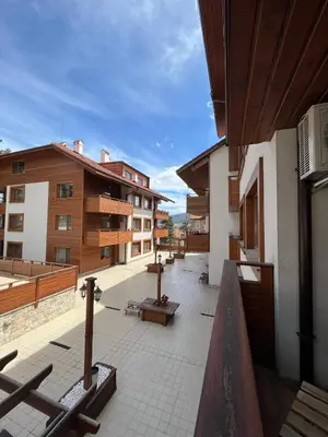 a balcony of a building with benches and buildings at Апартамент Ренета Apartment Reneta in Velingrad