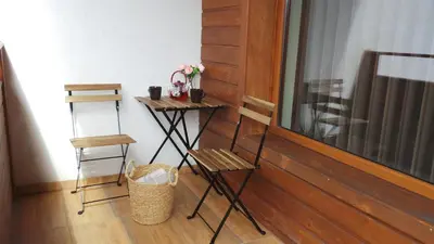 a room with a table and two chairs and a mirror at Апартамент Ренета Apartment Reneta in Velingrad