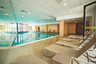 a swimming pool with lounge chairs and a swimming pool at SPA Apartments Perun in Sandanski