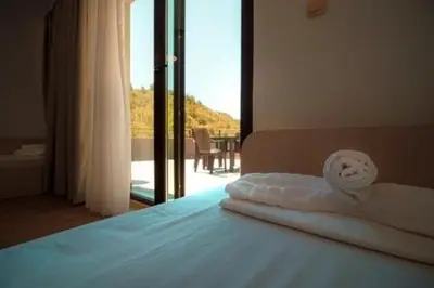 a bedroom with a bed with a view of a balcony at SPA Apartments Perun in Sandanski