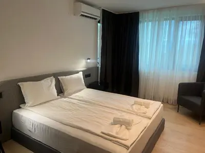a bedroom with a bed with two towels on it at SPA Apartments Perun in Sandanski