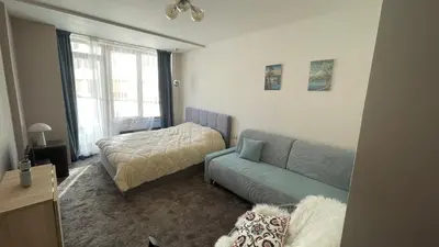 a living room with a couch and a bed at Borovets Hills Boro Boro Studio 35m2 in Borovets