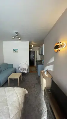 a living room with a blue couch and a kitchen at Borovets Hills Boro Boro Studio 35m2 in Borovets