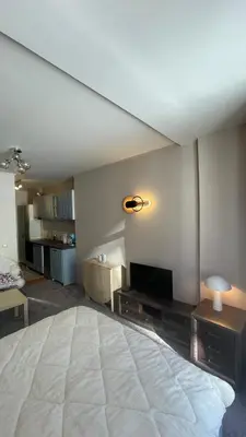 a bedroom with a large bed and a living room at Borovets Hills Boro Boro Studio 35m2 in Borovets