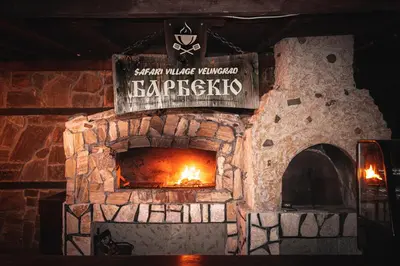 a stone fireplace with a sign that reads harpicks at Safari Village Velingrad in Velingrad