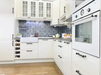 a kitchen with white cabinets and a sink at Vintage Top Centre Apartment in Sofia