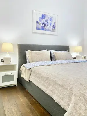 a bedroom with a large bed and two lamps at Vintage Top Centre Apartment in Sofia