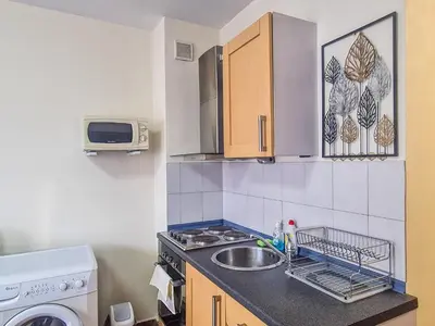a small kitchen with a sink and a microwave at Charming Flat in Bansko with Sauna by Flat Mаnager in Bansko