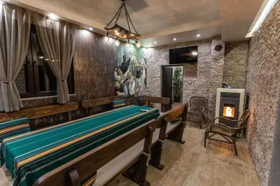 a room with two benches and a fireplace at Никонел in Oborishte