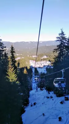 a ski lift in the middle of a snow covered slope at APARTAMENT-DAMO in Pamporovo