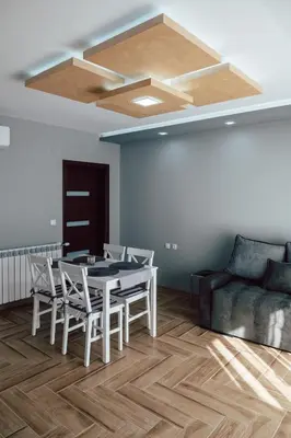 a living room with a table and chairs and a couch at Къща за гости Давиос in Sapareva Banya