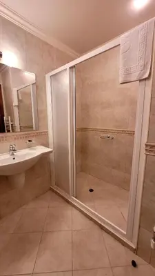 a bathroom with a shower and a sink at Cozy studio with balcony and incl SPA in 4-star hotel Saint Ivan Rilski , Bansko in Bansko