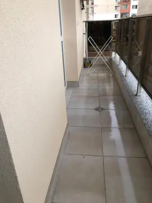a hallway in a building with a tile floor at Superb apartment Free Underground Parking in Pazardzhik