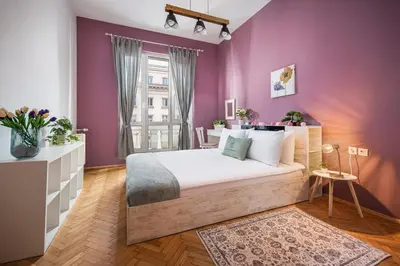 a bedroom with purple walls and a large bed at Free Parking And Parliament Is 1 Step Away in Sofia