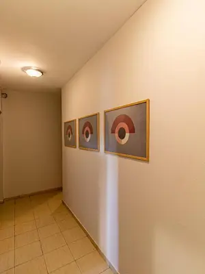 a hallway with three paintings on a wall at Vitosha Viewpoint - Chic City Studio in Sofia