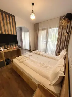 a bedroom with a large bed in a room at СПА Хотел Романтика in Sarnitsa