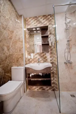 a bathroom with a toilet and a sink and a shower at СПА Хотел Романтика in Sarnitsa