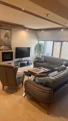 a living room with a couch and chairs and a television at Мезонет “Djanina” in Sandanski