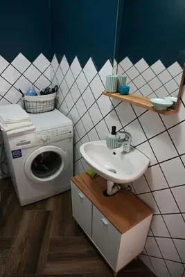 a bathroom with a sink and a washing machine at Studio Panagyurishte in Panagyurishte