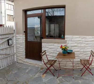 a patio with a table and two chairs and a window at Studio Panagyurishte in Panagyurishte