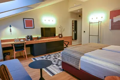 a bedroom with a bed and a desk with a computer at Едно Време in Karlovo