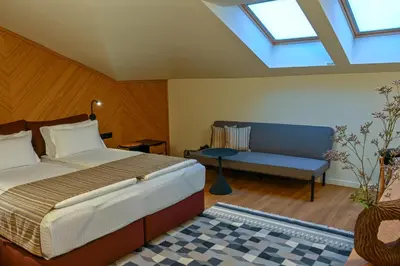 a bedroom with a bed and a couch at Едно Време in Karlovo