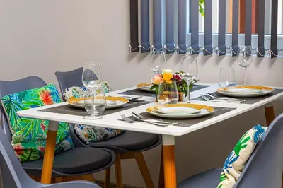 a table with plates and wine glasses on it at Florance flat next to Old Town & City Center NEW in Plovdiv