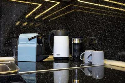 a counter with two cups and a coffee maker on it at Florance flat next to Old Town & City Center NEW in Plovdiv