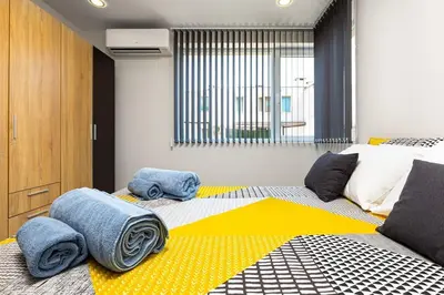 a bedroom with a large bed with towels on it at Florance flat next to Old Town & City Center NEW in Plovdiv