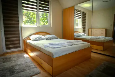 a bedroom with two twin beds and a mirror at Apart Centar in Plovdiv