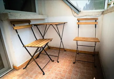two desks and two stools in a room with a window at Apart Centar in Plovdiv