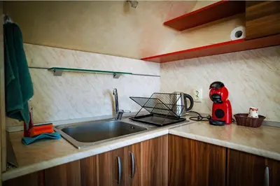 a kitchen counter with a sink and a red mixer at Apart Centar in Plovdiv