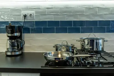 three pots and pans on a stove in a kitchen at Sofia Apartment with Free Parking in Sofia