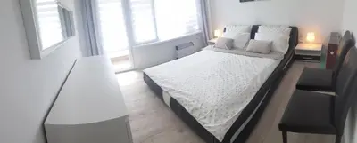 a bedroom with a bed with white sheets and pillows at 2 bdrm appartment in Sofia - Lulin in Sofia