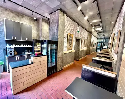 a large room with a kitchen with counters and tables at Art Hotel 158 in Sofia