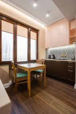 a kitchen with a wooden table and a table and chairs at Charming Pastel 1BD Flat in The Heart of Sofia by Flat Mаnager in Sofia