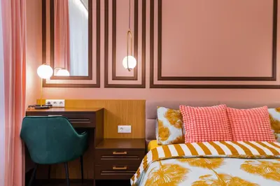 a bedroom with a bed and a desk and a chair at Charming Pastel 1BD Flat in The Heart of Sofia by Flat Mаnager in Sofia