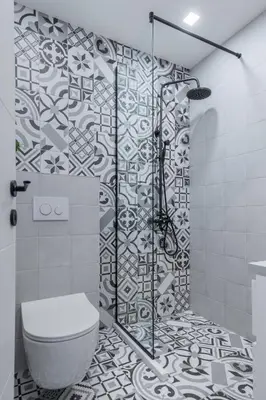 a bathroom with a toilet and a glass shower at Charming Pastel 1BD Flat in The Heart of Sofia by Flat Mаnager in Sofia