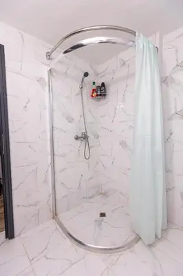 a shower with a shower curtain in a bathroom at Apartement Hérmitage in Sandanski
