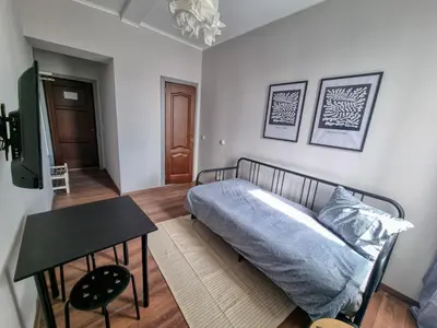 a bedroom with a bed and a table in it at Cozy Studio in Center of Sofia in Sofia